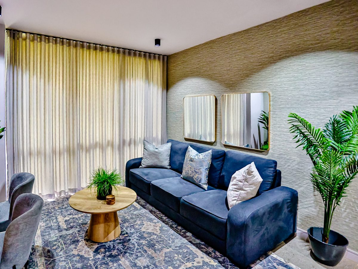 The living room at Unit 112: sofa, coffee table and work desk